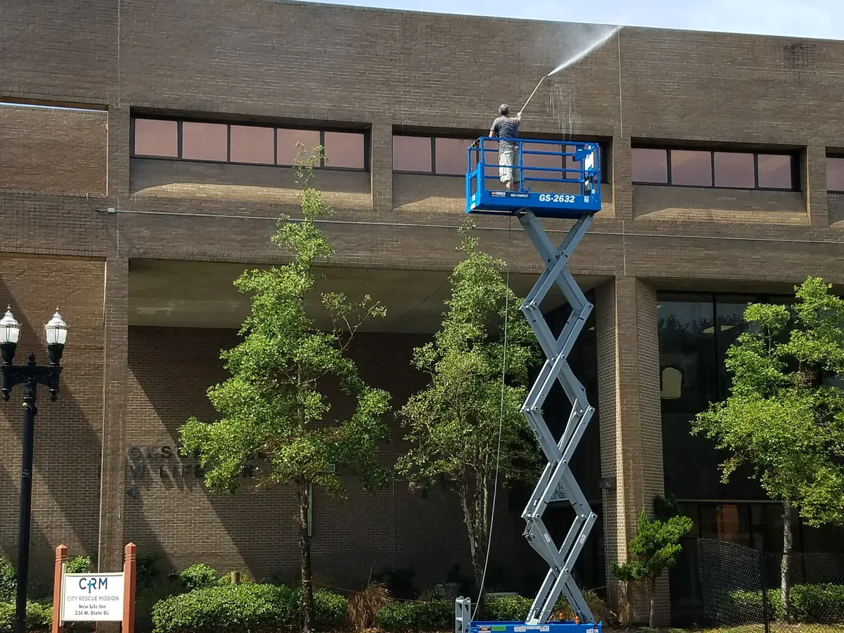 Scissor-lift pressure washing of the downtown Jacksonville mission campus exterior — Safe Touch archive job