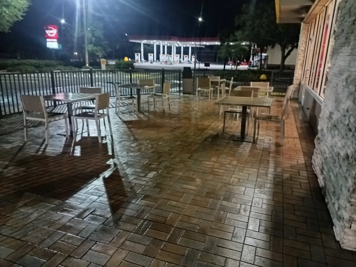 Freshly pressure-washed paver patio and outdoor seating at a McDonald's in Jacksonville, 2026