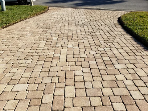 The same paver driveway after cleaning with a brighter surface