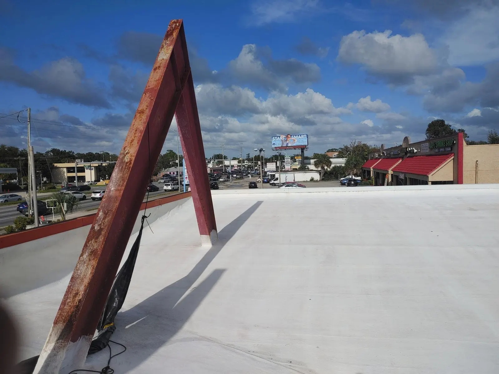 Flat white commercial roof with steel supports